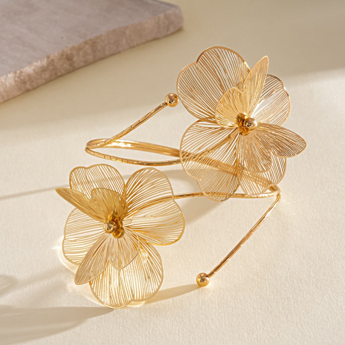 Gold tone hollow double layered flower open upper arm cuff boho statement jewelry flat lay
