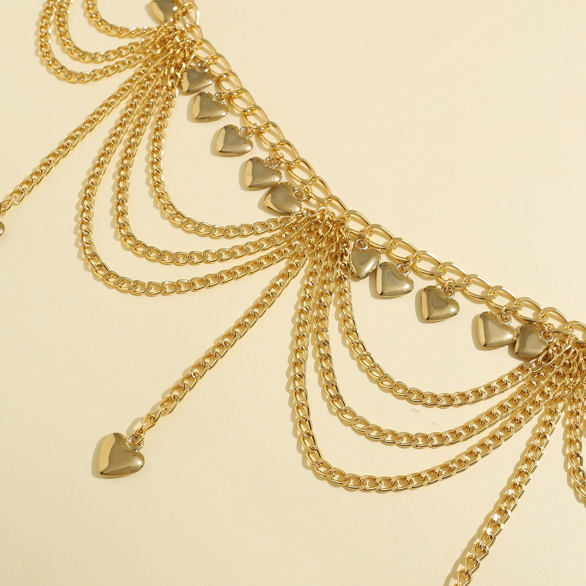 	Close-up view of gold-plated waist chain with multi-layered tassel design and small bells